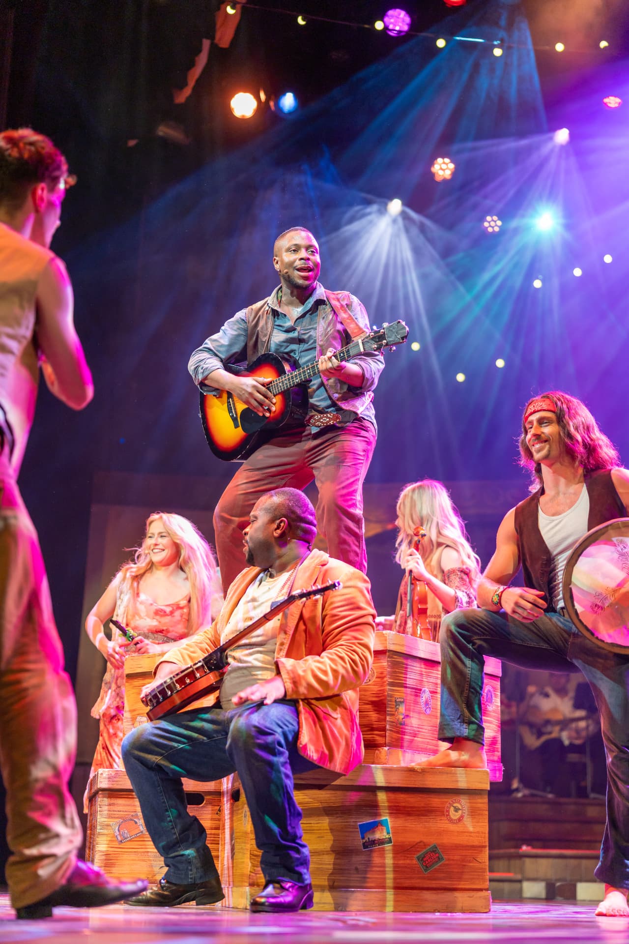 Performers appearing in a colorful live stage production.